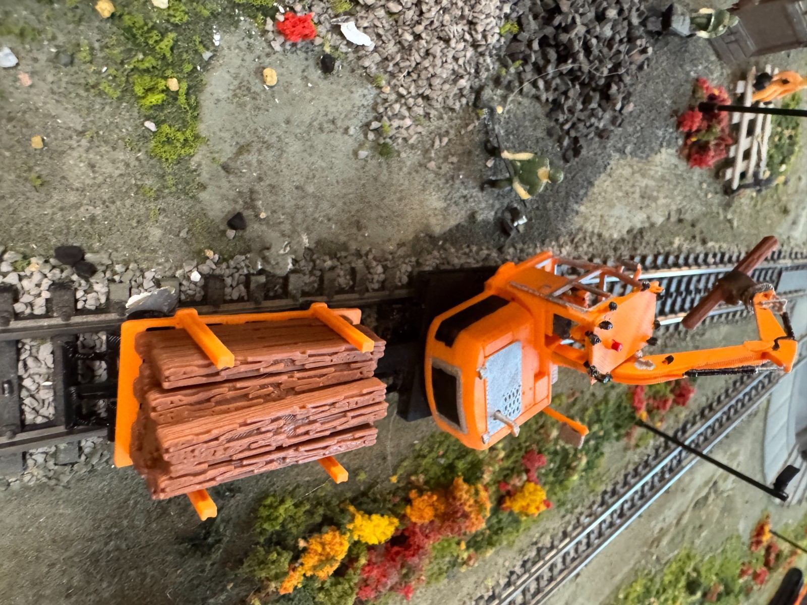 Ho scale Cat Railroad Tie Loader with loaded cart in Orange unpainted
