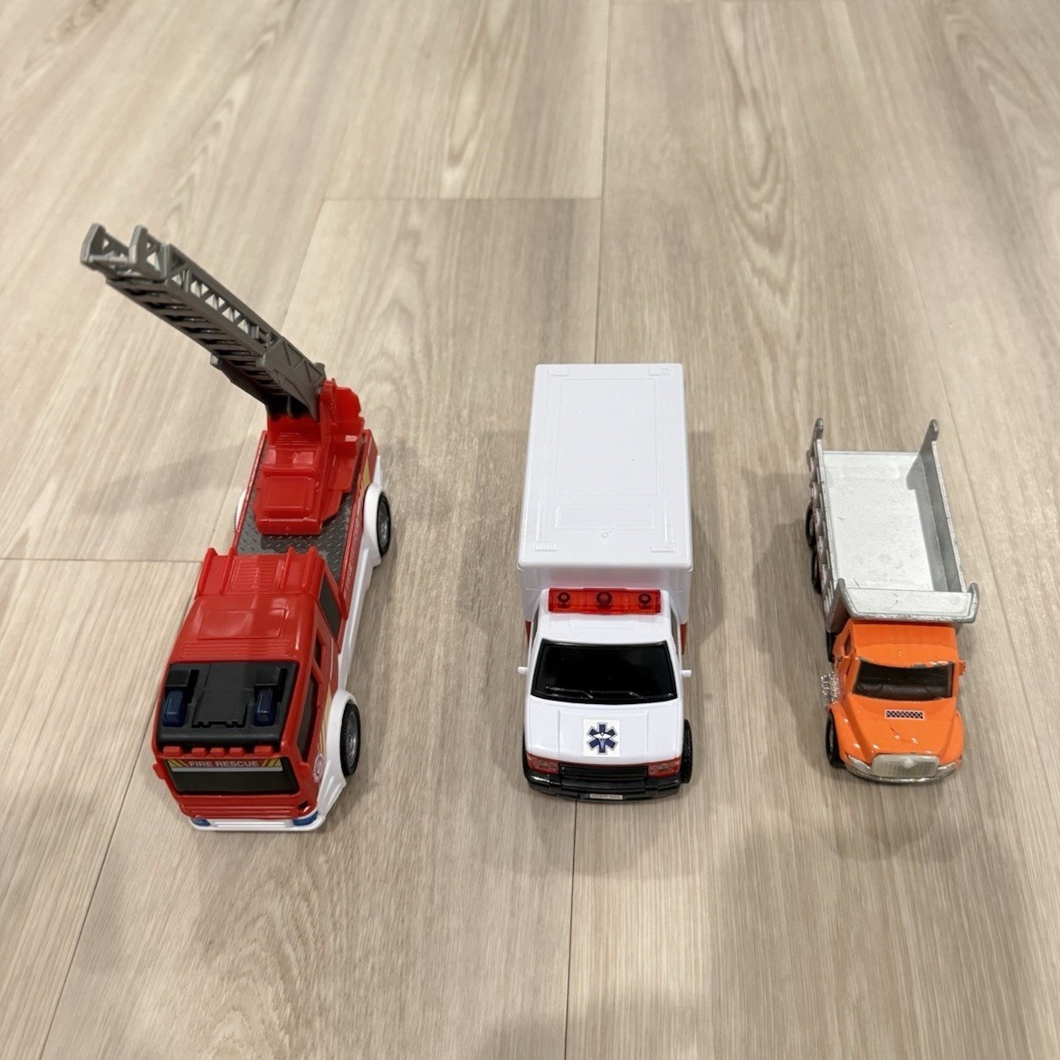 Lot of 3 vehicles: fire truck, ambulance, and dump truck.