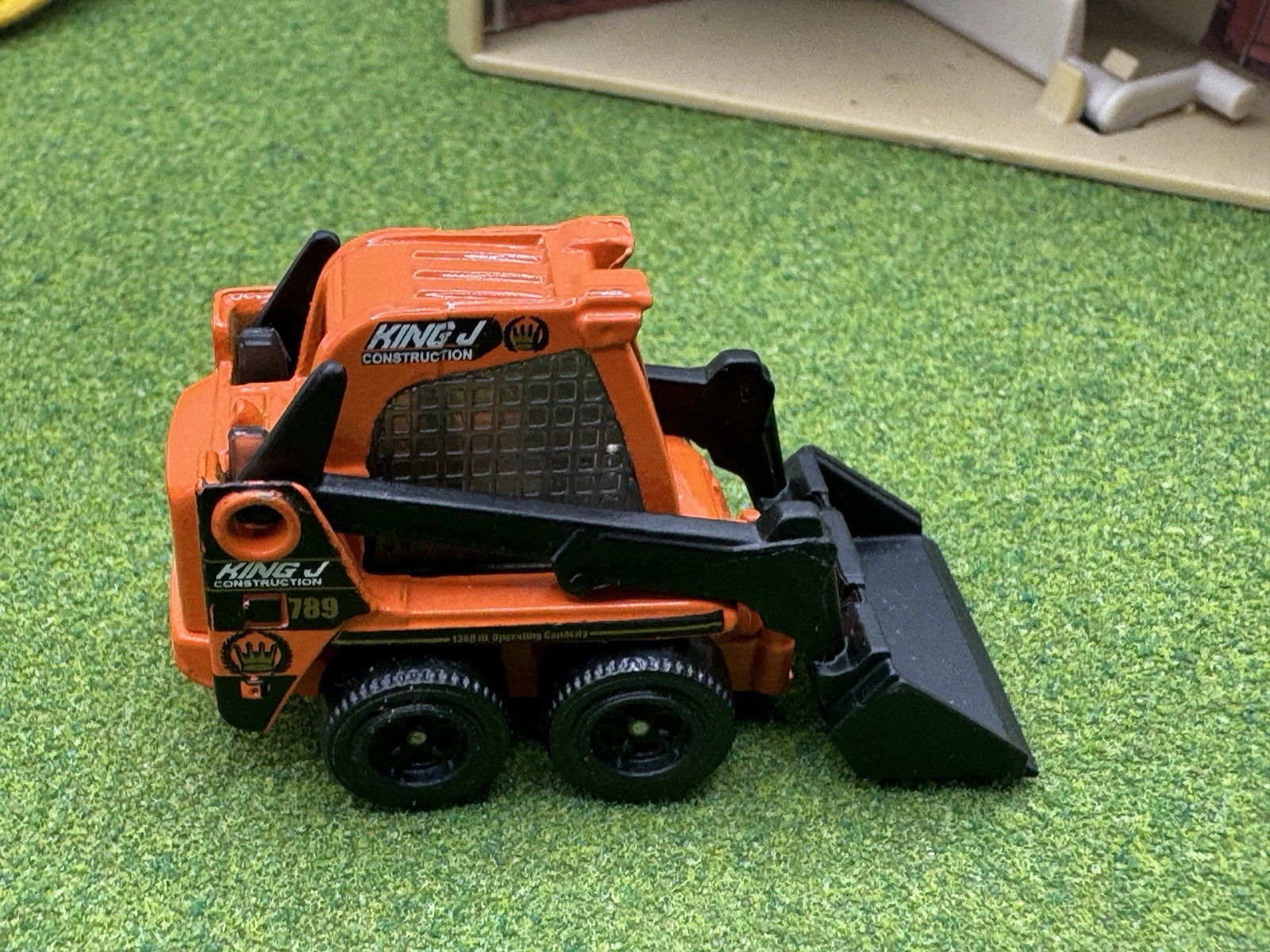 2009 Matchbox Skidster Orange KING J Bucket Construction Skid CAT Black