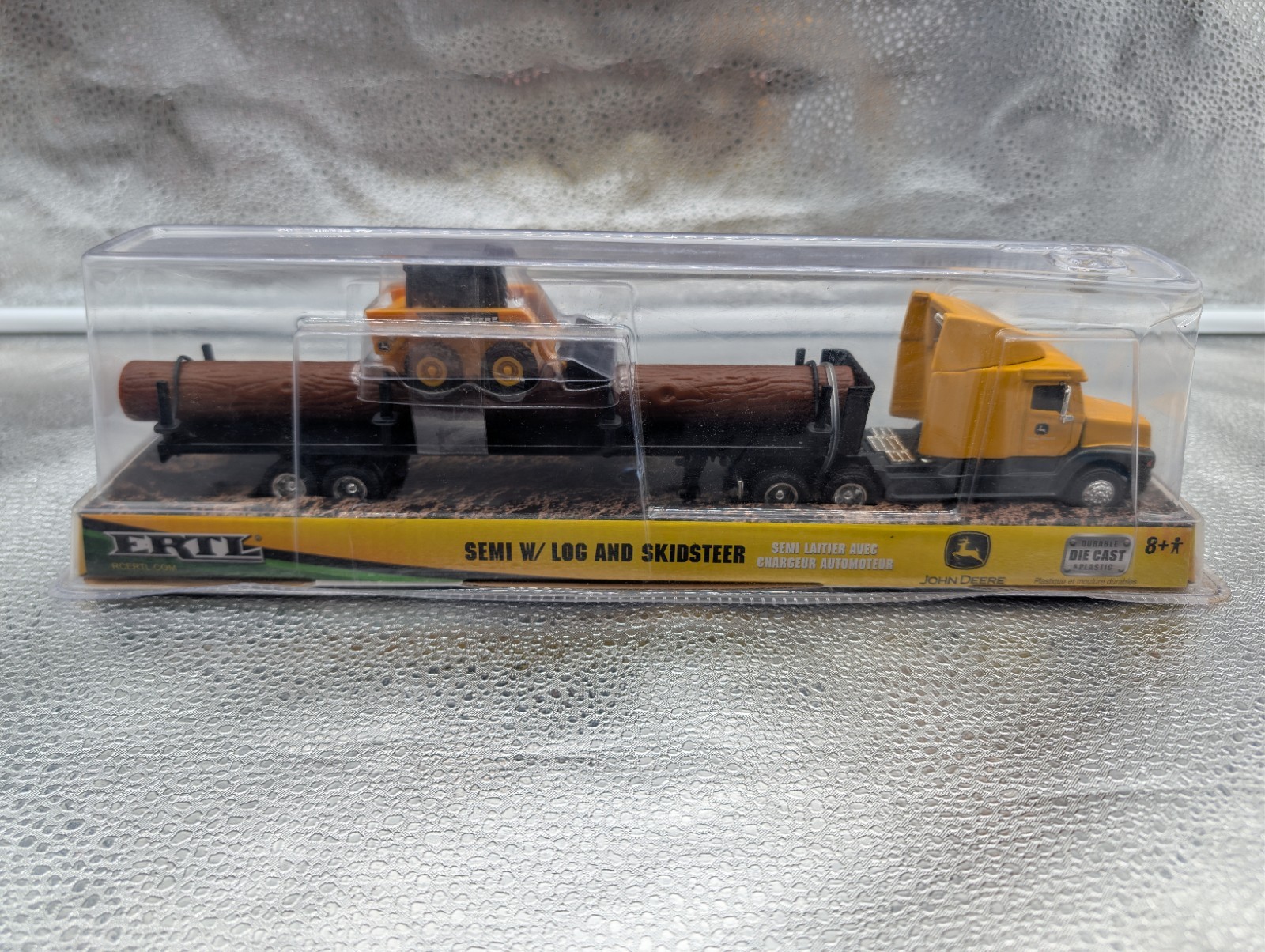 JOHN DEERE – ERTL SEMI W/ LOG AND SKIDSTEER 37382